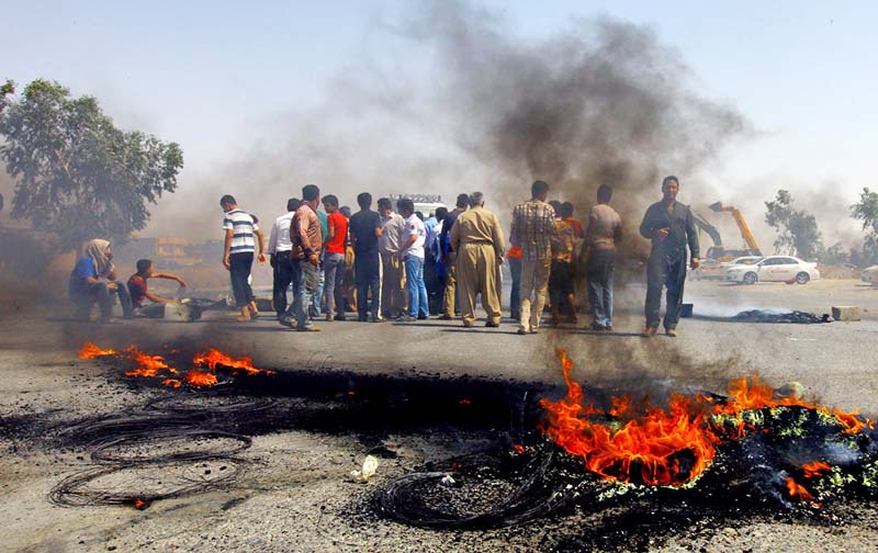 Iraqi Kurds block a road during a demonstration against the fuel crisis in Irbil. In Irbil, a city controlled by ethnic Kurds, lines stretched for miles at gas stations for weeks causing demonstrations.