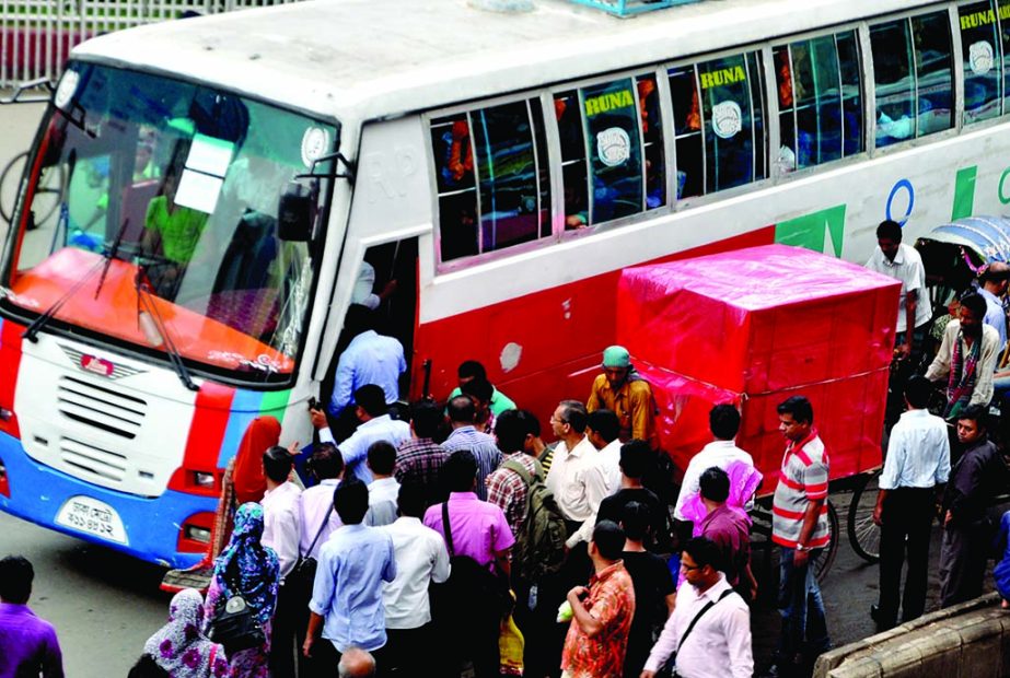 Passengers in a frantic struggle to get in to a bus as the transports were not available due to traffic snarl. The snap was taken from the city's Motijheel on Thursday.